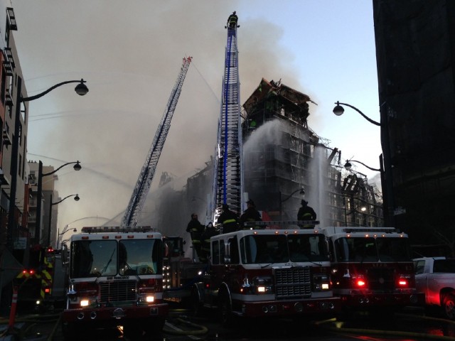 Firefighters work to contain a five-alarm fire at Fourth and China Basin streets in Mission Bay. (Charla Bear/KQED)
