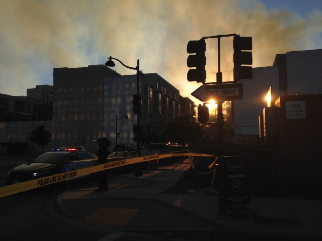 The sun sets, highlighting the smoke from the 5-alarm fire. (Jeremy Raff/KQED)