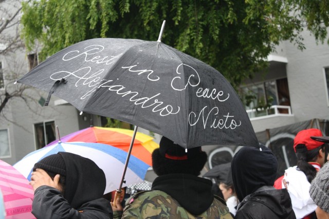 About 500 people marched in the rain Saturday, March 29, from San Francisco's Mission District to Bernal Heights Park, where 28-year-old Alejandro Nieto was shot and killed by police officers a week before. (Alex Emslie/KQED)