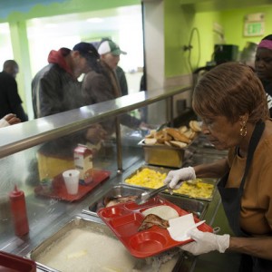 Volunteers serve breakfast to those in need at Mother Brown's Dining Room. (Mark Andrew Boyer/KQED)