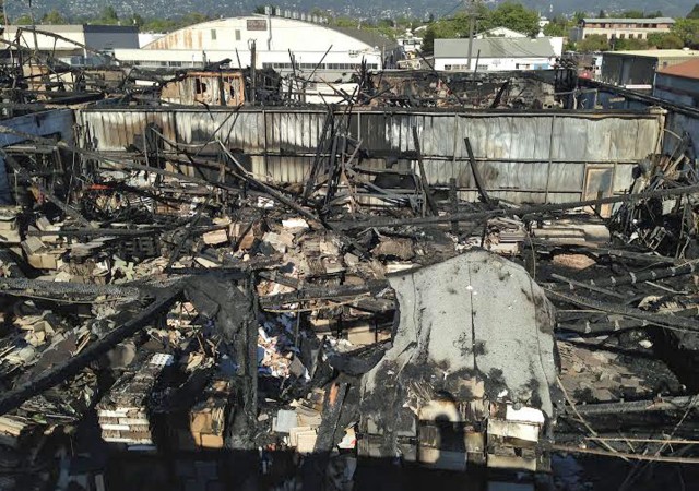 The remains of The Wooden Duck warehouse, as seen from above, after a five-alarm fire Saturday, April 12. Some of the businesses at the location on Berkeley’s Eastshore Highway survived largely intact, but 20 artisans whose equipment and crafts were housed in the same building complex lost everything. (Todd Forbush/Berkeleyside)