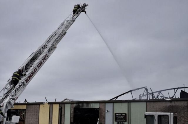 Firefighters continued to dose the building with water on Sunday morning, April 13. (Pete Rosos/Berkeleyside)