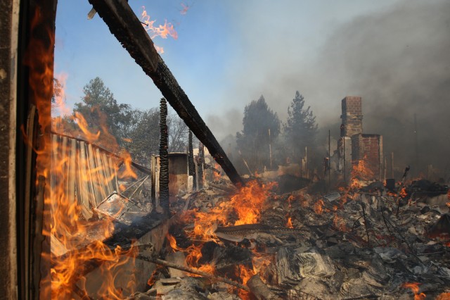 A house burns at the Cocos fire on May 15, 2014 in San Marcos, California. (David McNew/Getty Images)