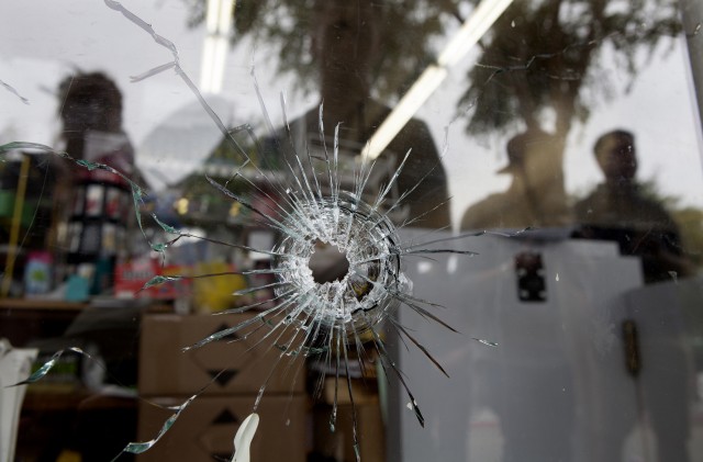 Bullet holes in the IV Deli Mart, one of several crime scenes Saturday, May 24, 2014. (Spencer Weiner/Getty Images)