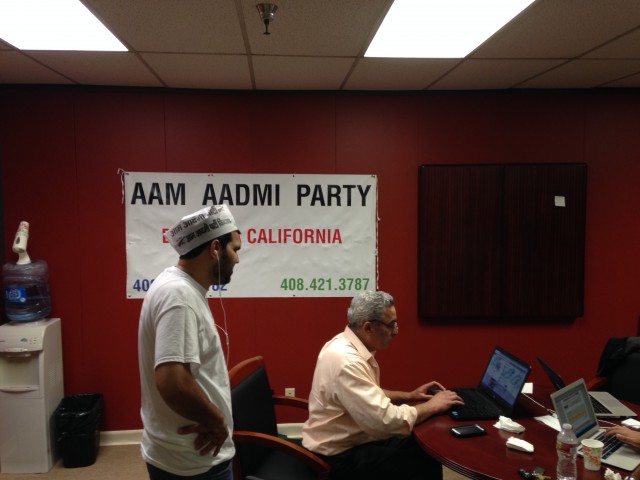 Parwaz Virk, left, and Dilawar Chahal volunteer for the Aam Aadmi Party, making phone calls to India to ask people for their votes from Chahal's office in Sunnyvale Friday, May 9. (Samantha Clark/KQED)