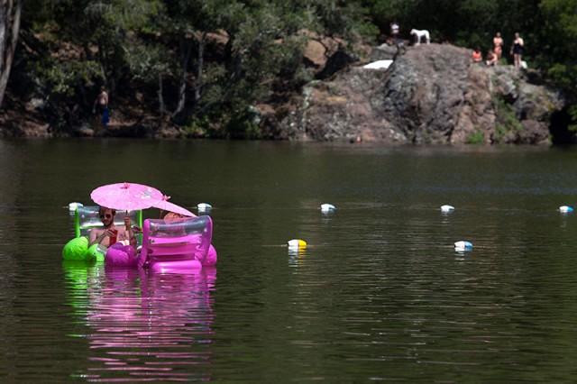 A couple floats on inflatable chairs in Lake Anza (Mark Andrew Boyer/KQED)