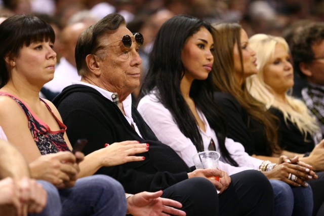 In happier times, Donald Sterling and V. Stiviano watch a basketball game together in May 2013 in San Antonio. (Ronald Martinez/Getty Images) 