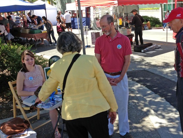 Candidate Steve Glazer and daughter Alex talk to voters at the Walnut Creek farmer's market. (Cy Musiker/KQED)