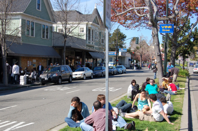 People routinely eat on the Shattuck Avenue median near the Cheese Board. New parklets might change that. (Jason/Flickr)