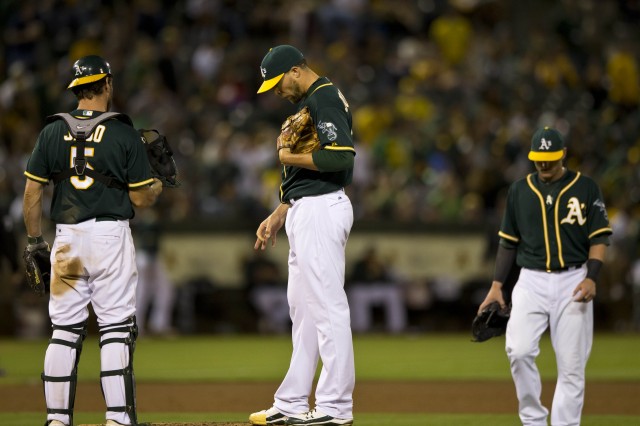 The Oakland A's Jim Johnson, center, on the  mound Wednesday night during the latest in a string of disastrous outings. (Jason O. Watson/Getty Images)