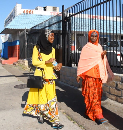 Isha Aweyso and her mother, Nuriya Abshiro walk through the Little Mogadishu district of City Heights in San Diego. (Brian Myers/Media Arts Center San Diego)