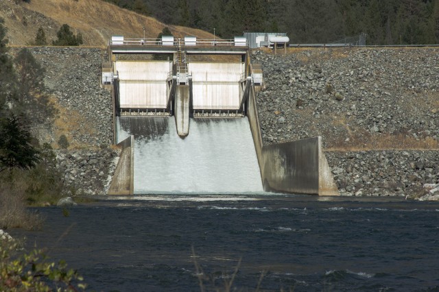 Water pounds down the spillway from Lewiston Dam on the Trinity River. The U.S. Bureau of Reclamation is increasing flows to aid migrating salmon. (Dan Brekke/KQED)