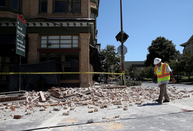 Dan Kavarian, chief building official with the City of Napa, surveys a building that was damaged by a 6.0 earthquake. (Justin Sullivan/Getty Images)