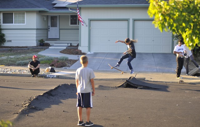 Kids skateboard over buckled roads in a residential neighborhood of Napa, California. (Josh Edelson/AFP/Getty Images)