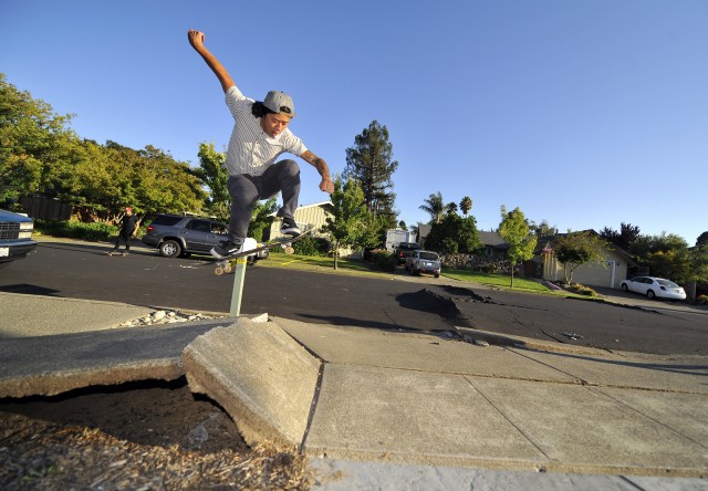Ryan Young skateboards over a buckled sidewalk in a residential neighborhood of Napa, California. (Josh Edelson/AFP/Getty Images)