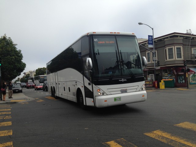 A commuter shuttle headed to Google's Mountain View campus pulls into a pre-approved Muni stop at 24th St and Valencia. 