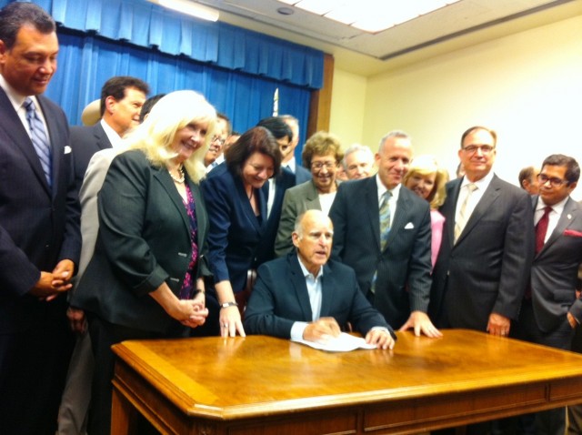 Governor Jerry Brown signs a $7.5 billion water bond Wednesday night. (Ben Adler / Capital Public Radio)