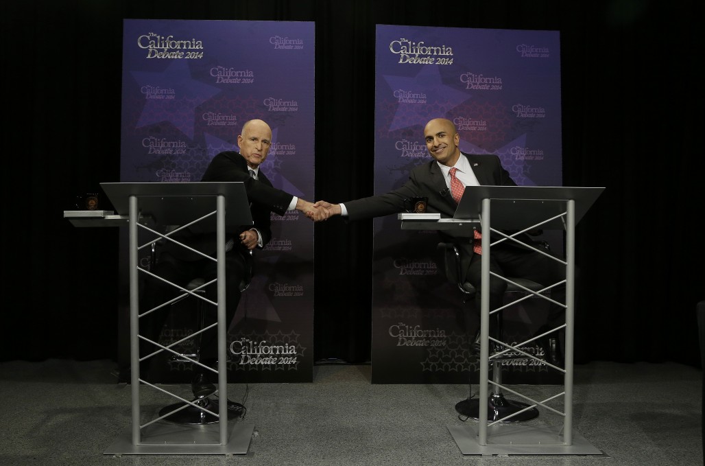 Gov. Jerry Brown, left, shakes hands with Republican challenger Neel Kashkari as they pose for photographs before a gubernatorial debate in Sacramento, Calif., Thursday, Sept. 4, 2014. (AP Photo/Rich Pedroncelli, Pool)