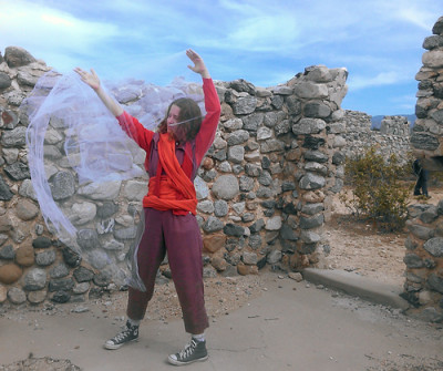 Dance theater artist Christine Suarez performs "Mother.Work" in the stone ruins of what was once a house at Llano Del Rio. (Avishay Artsy/KQED)