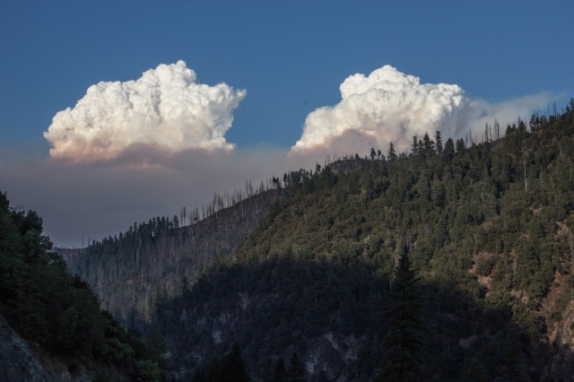The Happy Camp Complex wildfire, burning in the mountains south of the Klamath River in Siskiyou County, as seen from Highway 96 east of the town of Happy Camp last Thursday.  (Dan Brekke/KQED)