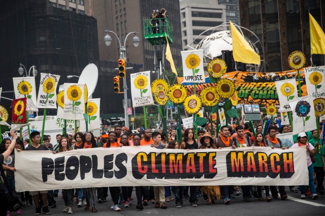  People protest for greater action against climate change during the People's Climate March on September 21, 2014 in New York City. The march, which calls for drastic political and economic changes to slow global warming, has been organized by a coalition of unions, activists, politicians and scientists.  (Andrew Burton/Getty Images)
