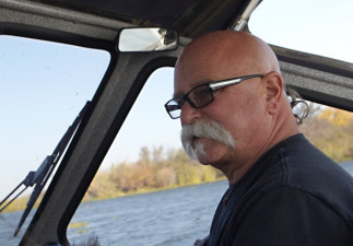 Mail carrier Rick Stelzreide at the helm of his boat. (Tony George/KQED)