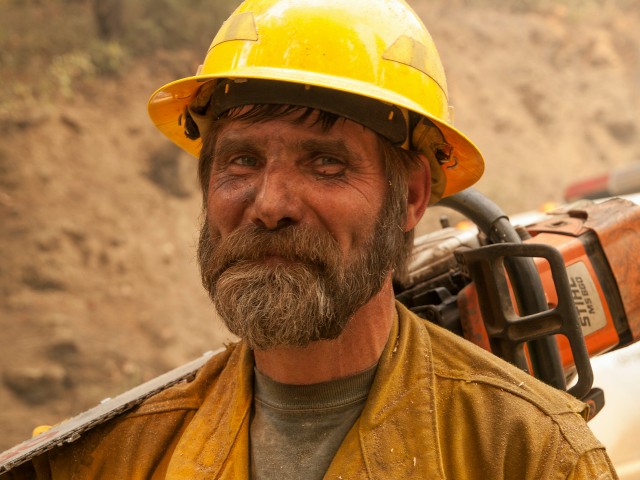 A feller--a firefighter whose particular expertise is felling trees that need to be cleared to create firebreaks, on the line of the Happy Camp Fire. (Kari Greer)