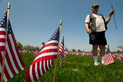 Roger Zay planting flags at Riverside National Cemetery a few days before Memorial Day 2013. (Douglas McCulloh)