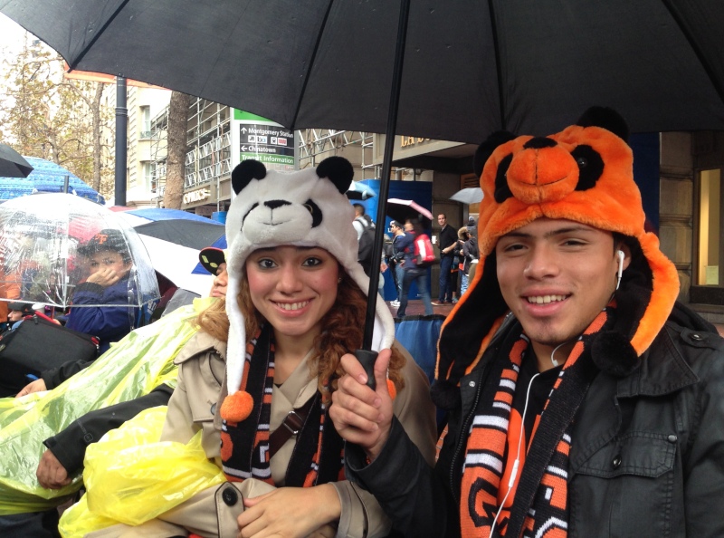 Aileen Castillo of Sacramento, with her brother Alejandro, came down from Sacramento for the Giants victory celebration. "We're ready for the rain -- we've got umbrellas, ponchos, raincoats-- we're fine." (Jeremy Raff/KQED)