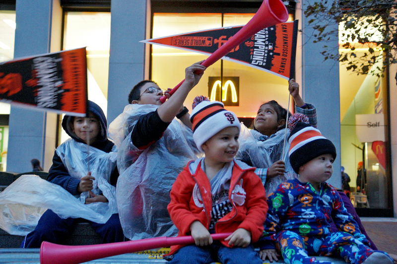 Rear left to right: Antonio, Carlos and Jissel Zermeno and LJ and William Martinez prepare for the Giants Parade on Market St. in San Francisco, Calif. on Friday, Oct. 31, 2014. The Zermenos drove hours to attend their first ever Giants parade. (James Tensuan/KQED)