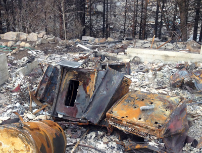 Many homes burned by the Boles Fire were fully leveled, with only the blackened husks of metal appliances left recognizable. (Daniel Potter/KQED)