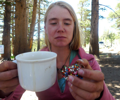 Shannon Pepper, trail name Pan, grabs fresh coffee and a doughnut at the Sonora Pass Cafe. (Lisa Morehouse/KQED)