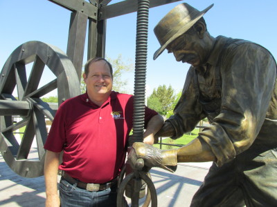 Taft Mayor Pro Tem Orchel Krier with the town's Oil Worker Monument. (Scott Shafer/KQED)