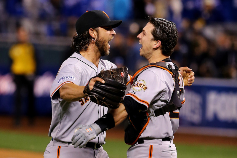 Buster Posey #28 and Madison Bumgarner #40 of the San Francisco Giants celebrate after defeating the Kansas City Royals to win Game Seven of the 2014 World Series. (Photo by Elsa/Getty Images)