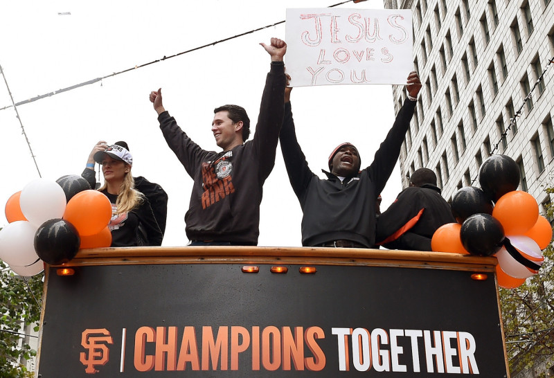Buster Posey (L) and Santiago Casilla (R) of the San Francisco Giants, waved to the crowd along the parade route during the San Francisco Giants World Series victory parade. (Thearon W. Henderson/Getty Images)