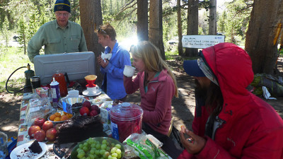 Hank Magnuski (L) feeds hikers, including some who took advantage of his wifi with their smartphones. (Lisa Morehouse/KQED)