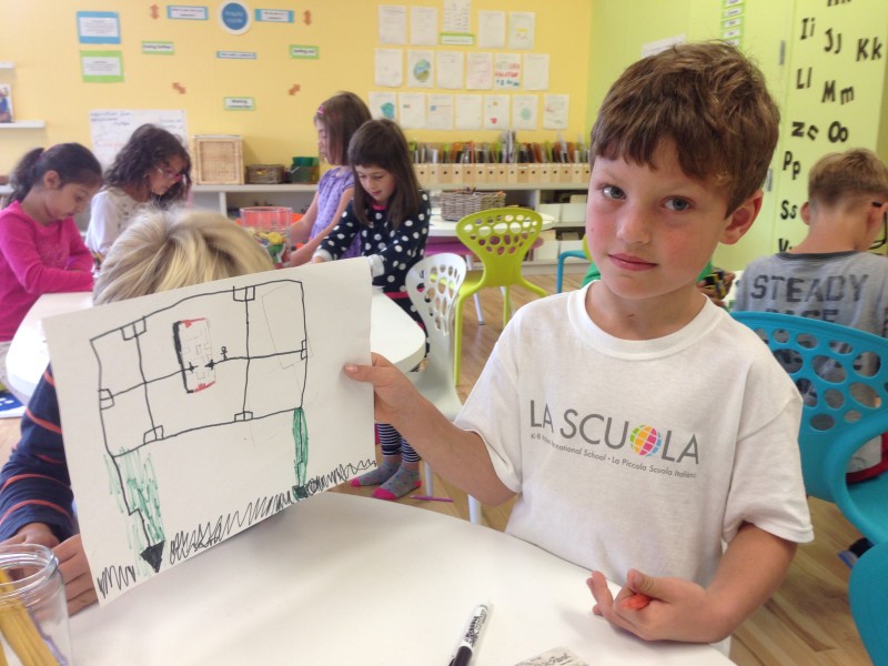 Aidan Mogal displays a drawing he made at La Scuola. Art is one of his favorite classes. (Patricia Yollin/KQED)