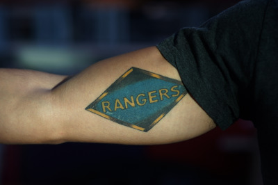 William Glazier shows off his tattoo that pays tribute to the 75th Ranger Regiment. (James Tensuan/KQED)