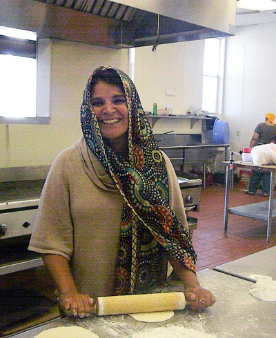 Editor Meeta Kaur rolls out a few chapatis at the Modesto Gurdwara Sahib. (Alice Daniel/KQED)