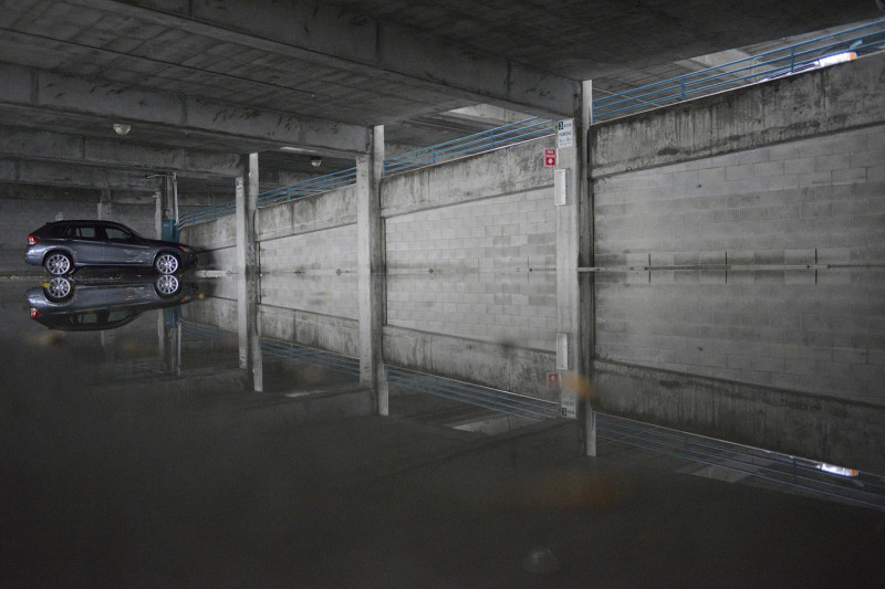 A lone car remains in a flooded parking garage off California Ave. in Palo Alto. (James Tensuan/KQED)