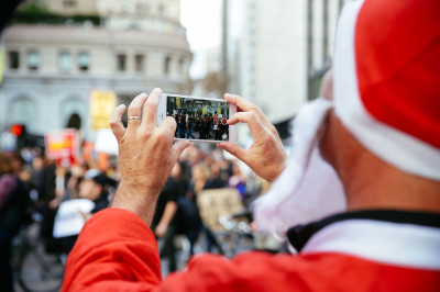 SantaCon, an annual Santa-clad pub-crawl, coincided with the march protesting police brutality.  (Jeremy Raff/KQED)