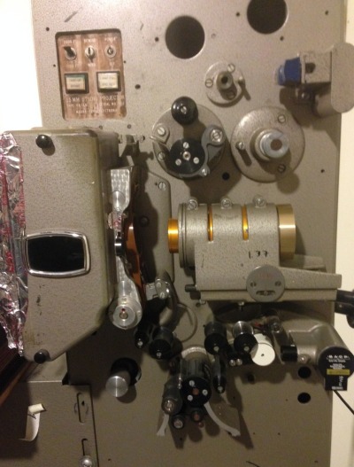 A film projector at Peter Conheim's "Small Back Room" home movie theater in El Cerrito. (Jon Brooks/KQED)