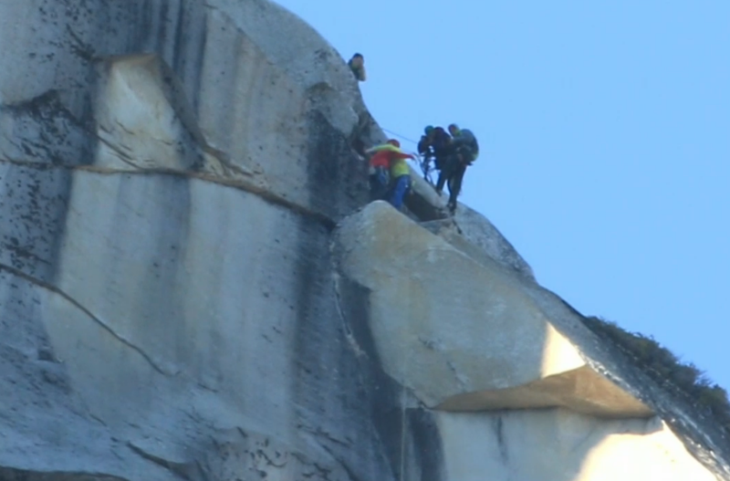 Climbers embrace near the top of the Dawn Wall. (Screenshot NBC)