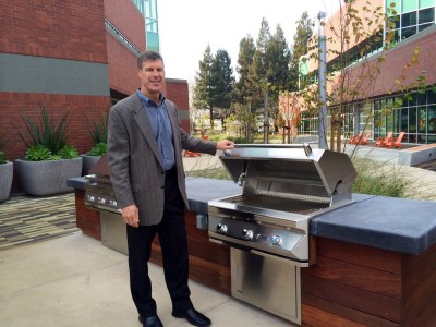 Phil Mahoney, executive vice president of Cornish & Carey in Santa Clara shows off the new grill at an old research and development building in North San Jose. It is one of many buildings being modified to make it marketable again.