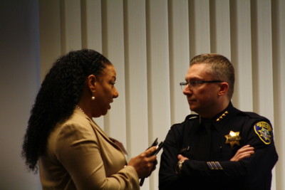 Olis Simmons, founder and CEO of Youth UpRising, speaks to Oakland Police Chief Sean Whent Feb. 5, 2015, before a roundtable discussion convened by U.S. Attorney General Eric Holder.