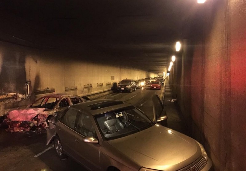 Cars involved in Monday morning crash and fire that shut down one of the Caldecott Tunnel's eastbound bores Monday morning, with abandoned vehicles in background. 