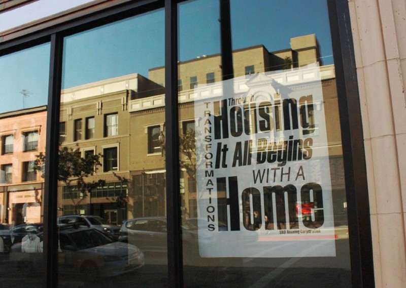 A sign on the window of the SRO Housing Corporation in Skid Row