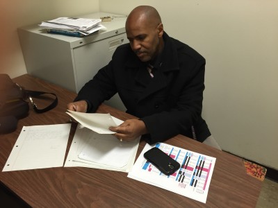 Visitacion Valley Assistant Principal Emmanuel Stewart pages through a stack of letters on Tuesday, April 7, that he received from students when they were disappointed about the cancellation of their march.