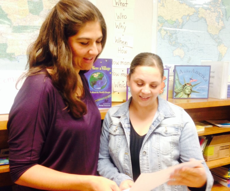 Student Hilda Sanchez (right) gets help from ESL teacher Sarah Motola.