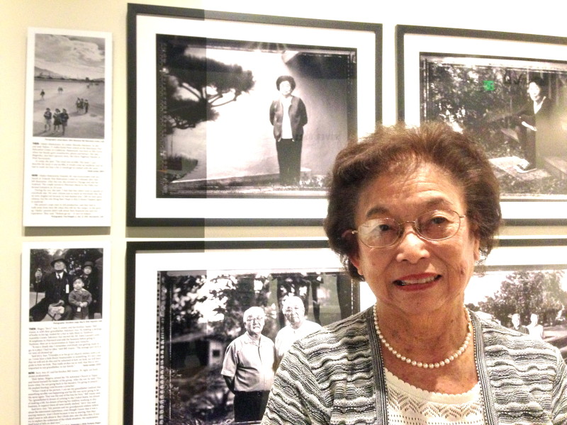 Gladys Matsumoto Katsuki stands in front of a 1943 Manzanar photo by Ansel Adams, top left, where she's in the middle. To its right is her portrait by Paul Kitagaki Jr. in 2012.